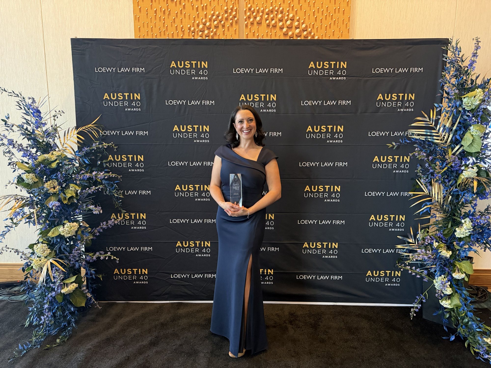 Lauren Goldstein holding her 2025 Austin Under 40 award
