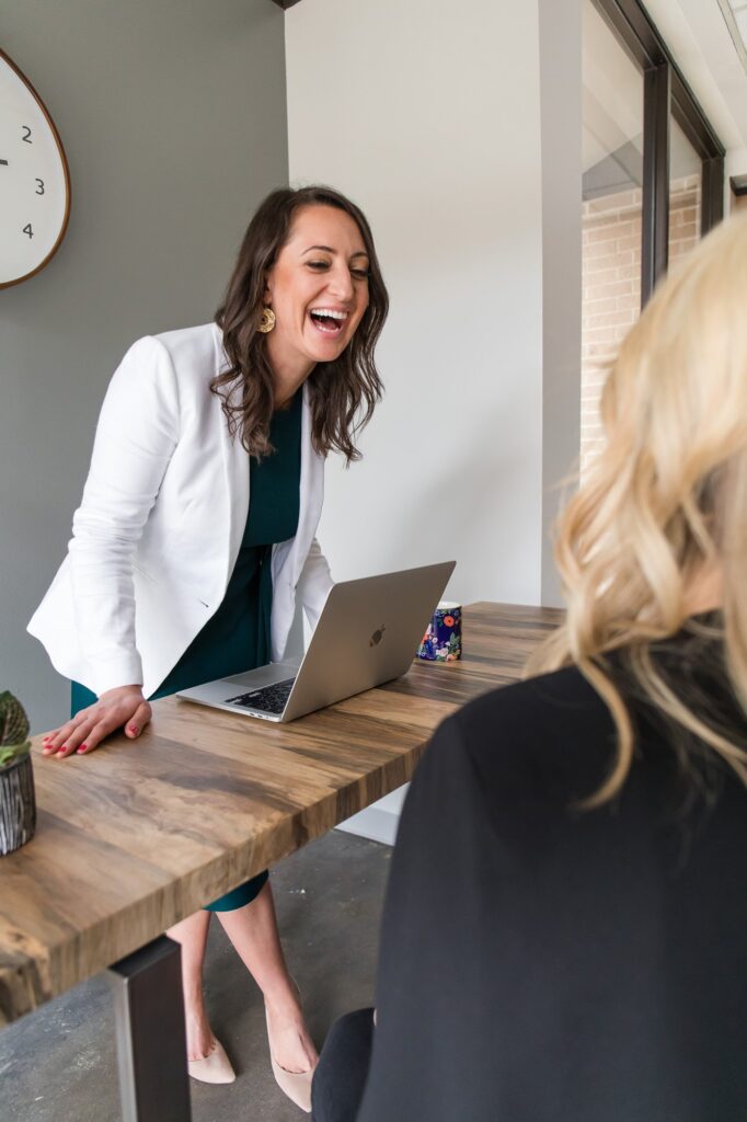 Lauren Goldstein laughing with a client during a working session