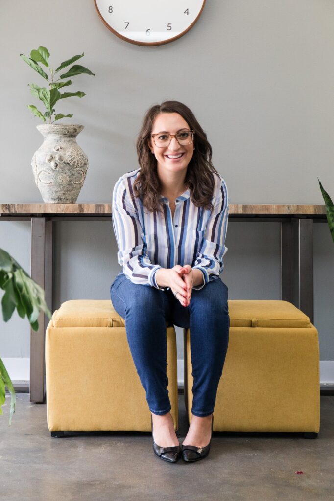 Lauren Goldstein seated in her office, smiling at the camera